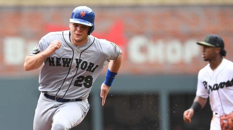 Mets catcher Devin Mesoraco races to third before scoring a...