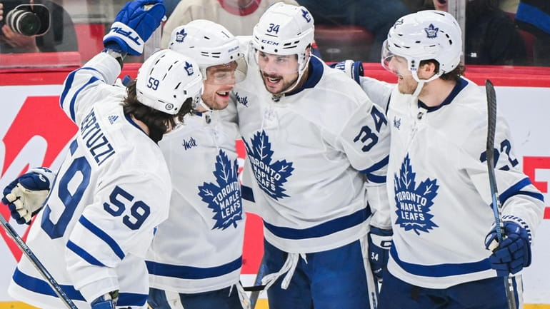 Toronto Maple Leafs' Auston Matthews (34) celebrates with teammates after...