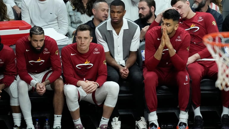 Miami Heat players react as they fall behind the Denver...