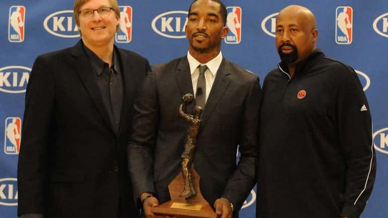 J.R. Smith, center, poses with Glen Grunwald, left, and Mike...