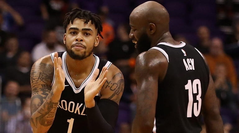D'Angelo Russell of the Nets reacts alongside Quincy Acy against...