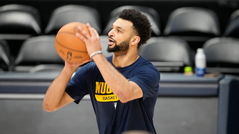 Denver Nuggets guard Jamal Murray warms up during practice for...