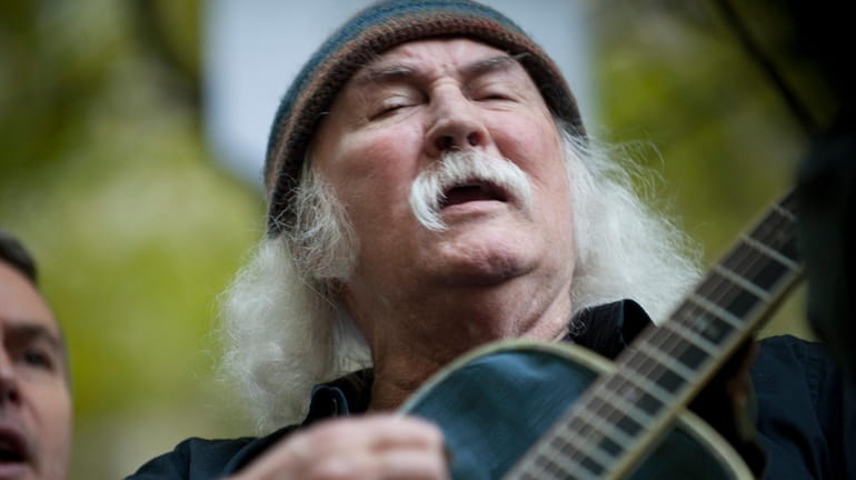 David Crosby, with guitar, performs for the Occupy Wall Street...