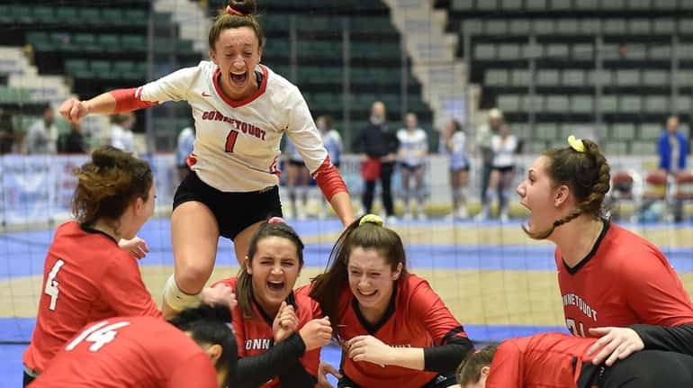 Julia Patsos and Connetquot teammates celebrate their state championship after defeating...