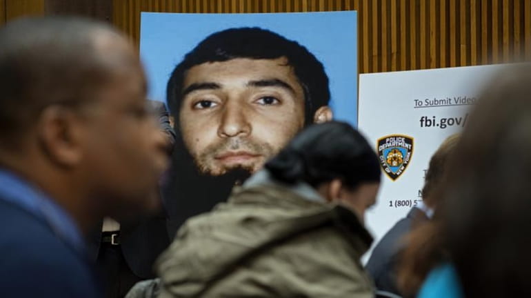 A photo of Sayfullo Saipov is displayed at a news...