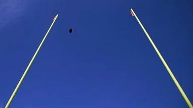 A football flies through the uprights during warmups before an...