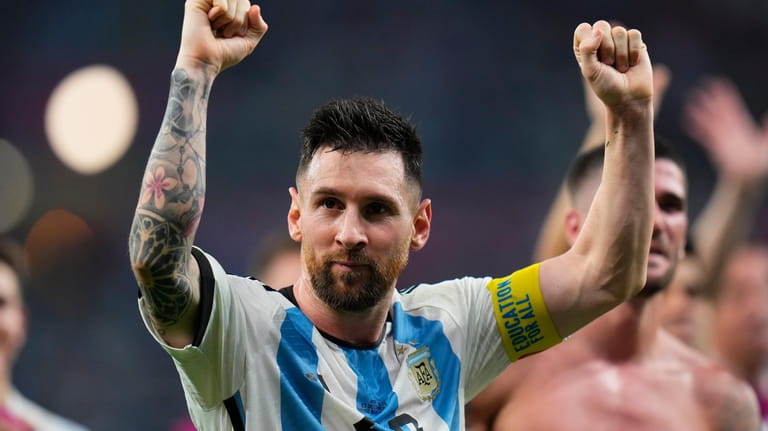 Argentina's Lionel Messi celebrates winning the World Cup round of...
