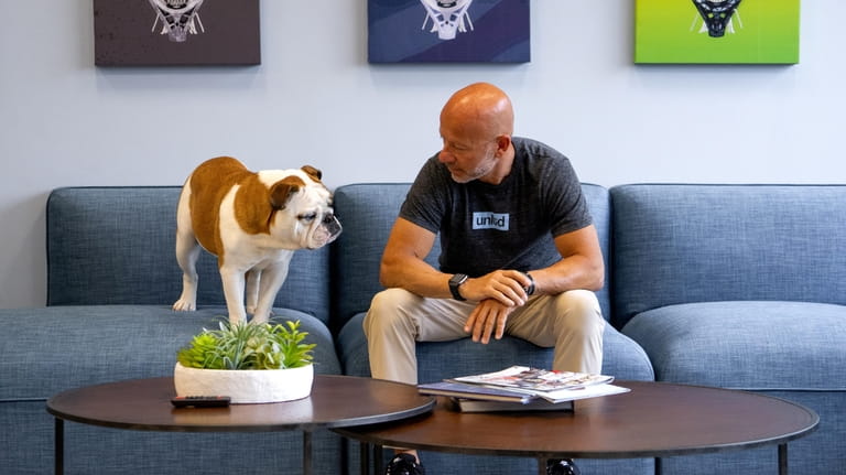 Joe DeSimone, Founder/CEO of Edgewood-based Lacrosse Unlimited and his bulldog...