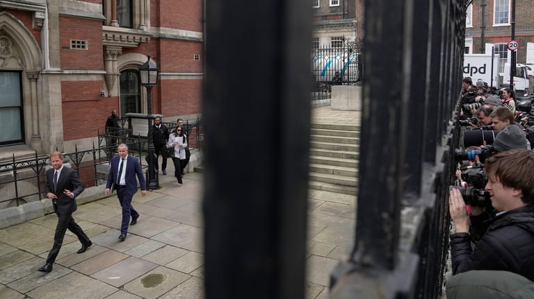 Britain's Prince Harry leaves the Royal Courts Of Justice as...