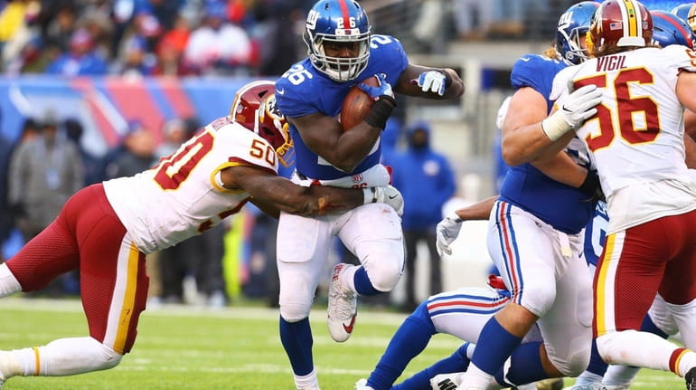 Orleans Darkwa of the Giants rushes the ball against the...