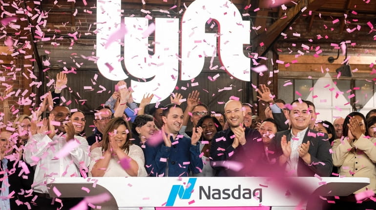 Lyft co-founders John Zimmer, front third from left, and Logan...