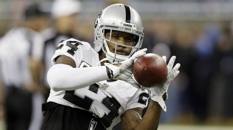 Oakland Raiders free safety Charles Woodson (24) catches a ball...