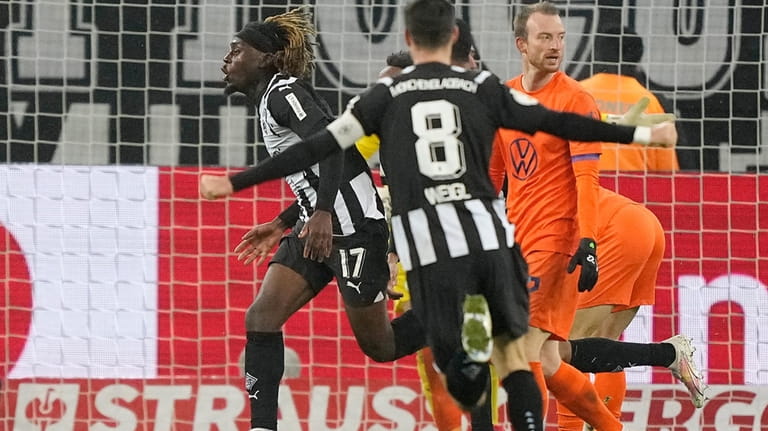 Moenchengladbach's Manu Kone celebrates after scoring the winning goal during...