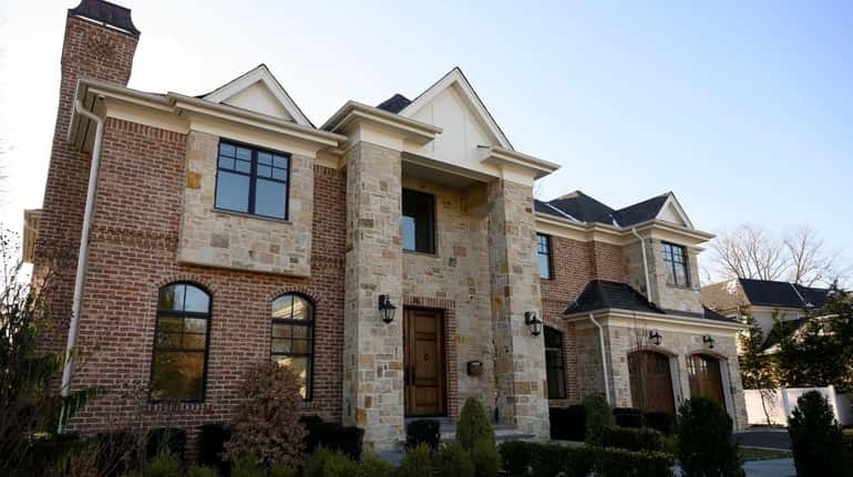 This six-bedroom, 6½-bath brick and stone Colonial in Roslyn Heights is on the...