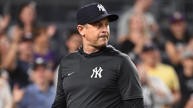 Yankees manager Aaron Boone walks back to the dugout after...