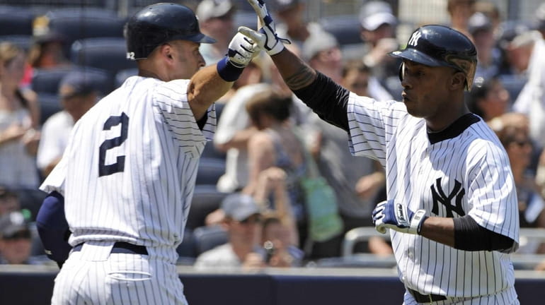New York Yankees' Dewayne Wise, right, celebrates with Derek Jeter...