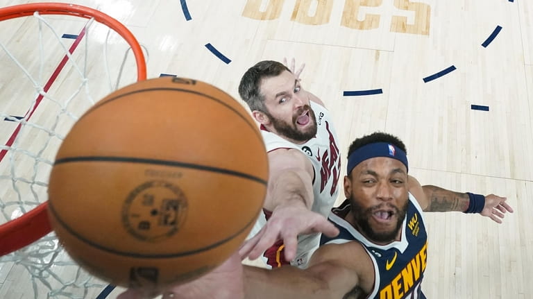 Denver Nuggets forward Bruce Brown, right, shoots while defended by...