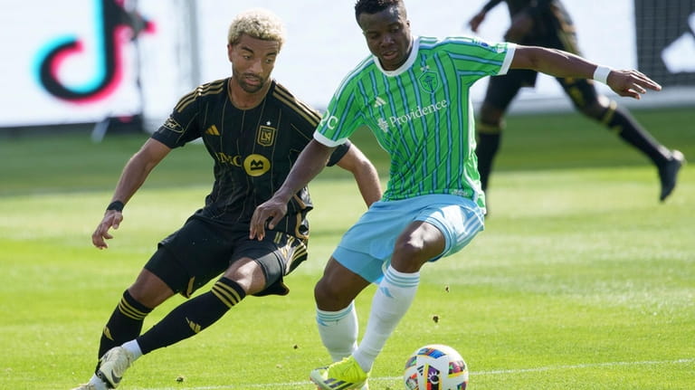 Seattle Sounders defender Nouhou Tolo, right, and Los Angeles FC...
