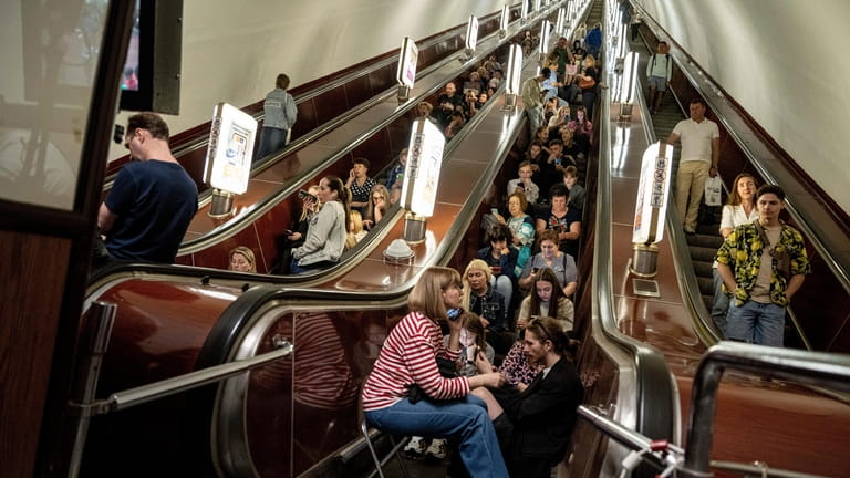 People take cover at metro station during a Russian rocket...