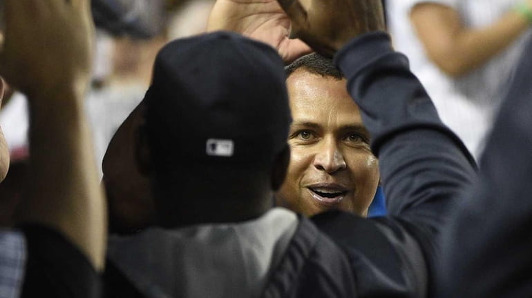 New York Yankees designated hitter Alex Rodriguez is greeted in...