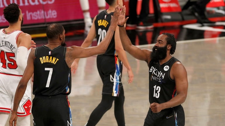 Kevin Durant #7 and James Harden #13 of the Nets...