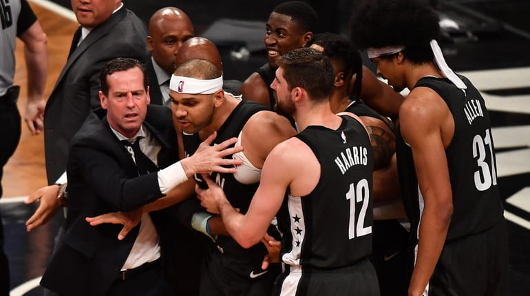 Nets head coach Kenny Atkinson grabs Nets forward Jared Dudley with...