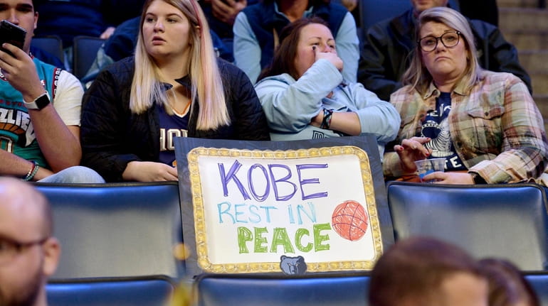 A sign reading "Kobe Rest In Peace" is displayed on...