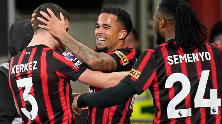 Bournemouth's Justin Kluivert, centre, celebrates with teammates after scoring the...