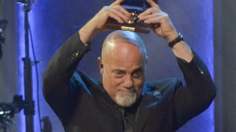 Billy Joel holds up his 2014 Gershwin Prize for Popular...