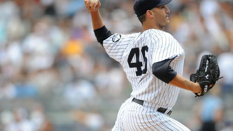 Yankees starting pitcher Andy Pettitte delivers in the first inning...