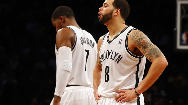 Deron Williams and Joe Johnson look on late in a...