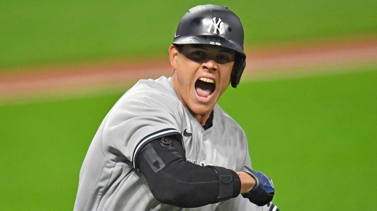 Gio Urshela of the Yankees tosses his bat after hitting a grand...