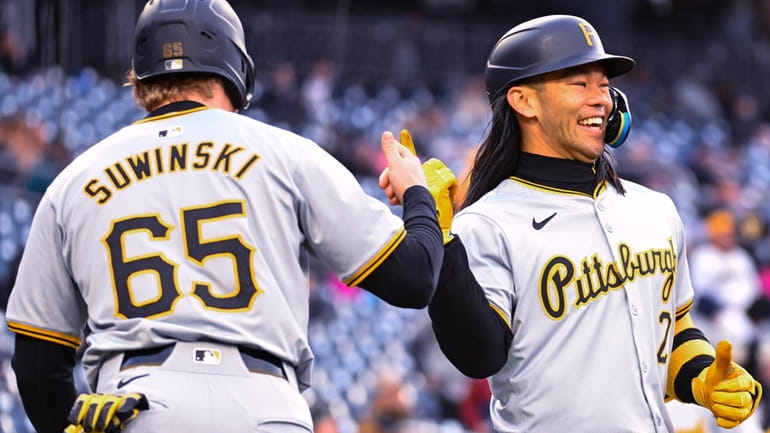 Pittsburgh Pirates' Connor Joe, right, celebrates his two-run home run...