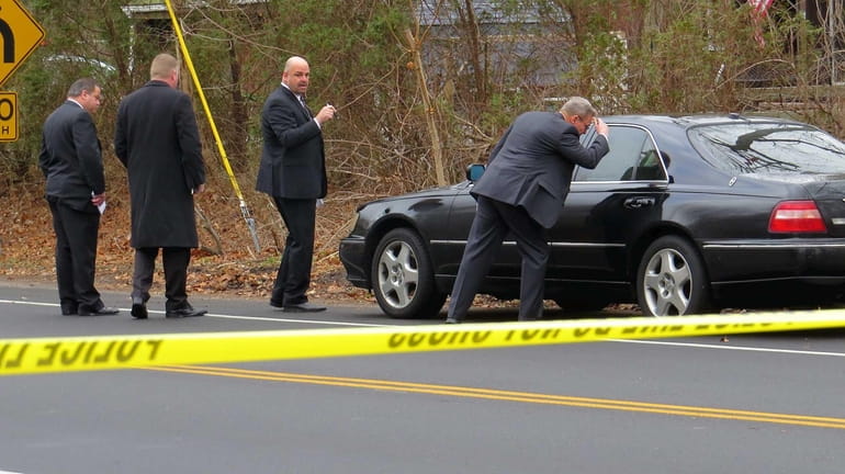 Suffolk County police investigators at scene of a body found...