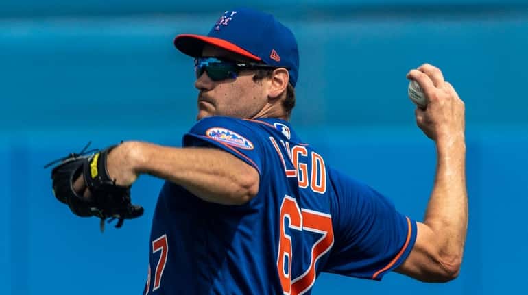 Mets pitcher Seth Lugo throws during a spring training workout...