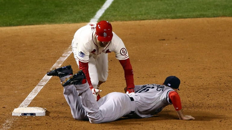 Allen Craig of the St. Louis Cardinals gets tripped up...