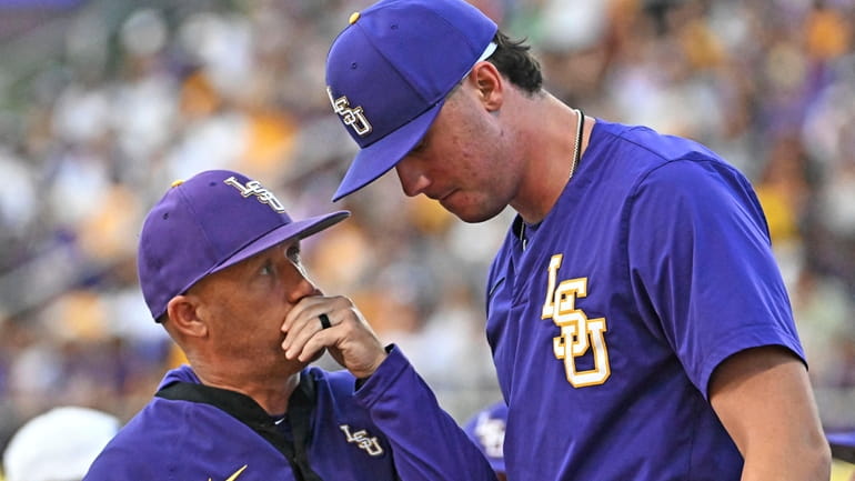 LSU pitching coach Wes Johnson, left, speaks with starting pitcher...