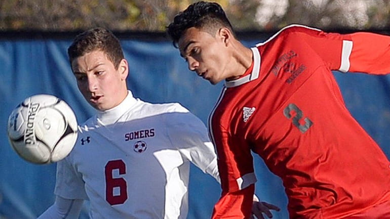 Amityville's Kevin Medrano, right, challenges for a header against Somers'...