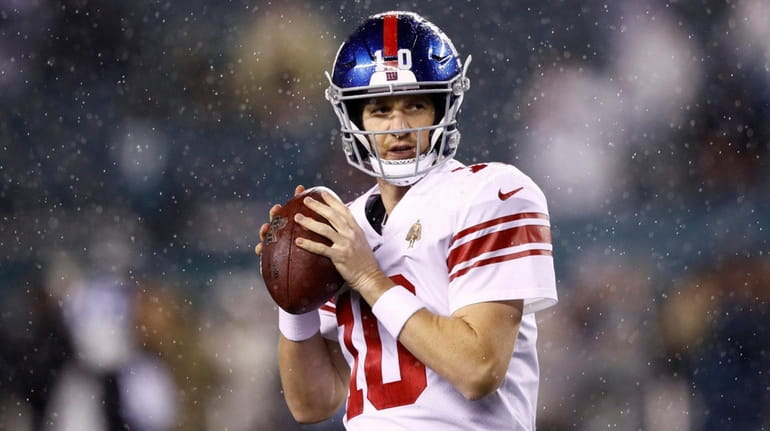 Giants quarterback Eli Manning warms up before a game against the...