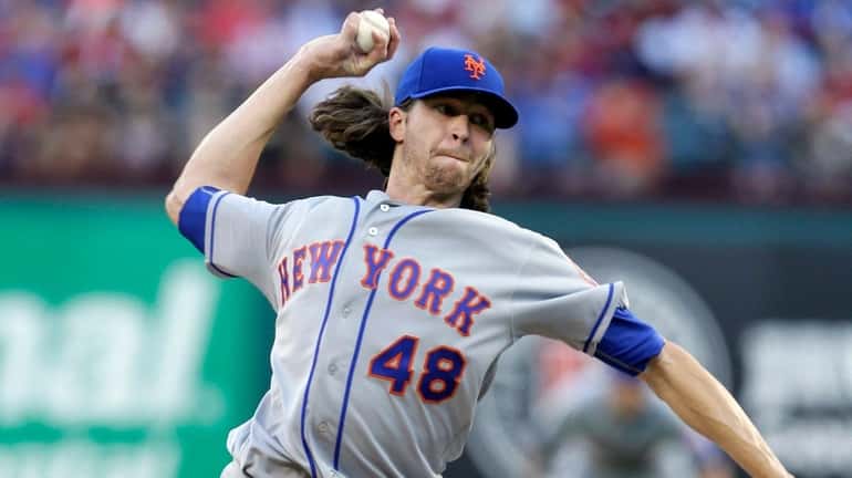 New York Mets starting pitcher Jacob deGrom throws to the...