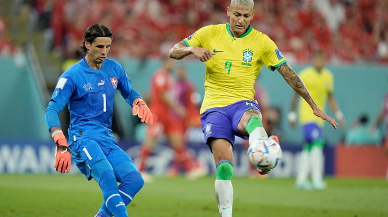 Brazil's Richarlison, right, tries to block as Switzerland's goalkeeper Yann...
