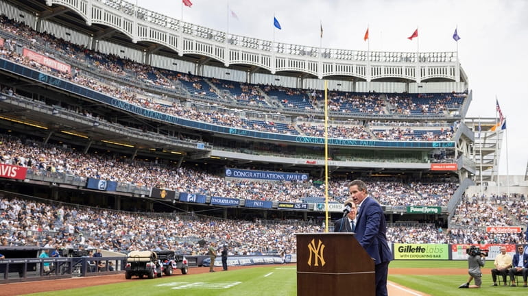Retired Yankees player Paul O'Neill speaks to fans during a number...