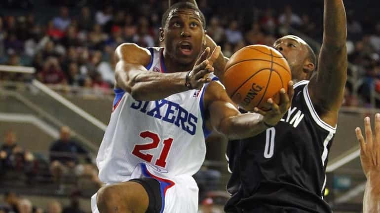 Philadelphia 76ers' Thaddeus Young goes up for a layup as...