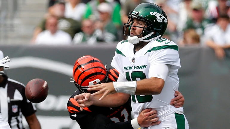 Joe Flacco #19 of the Jets loses the ball during the...