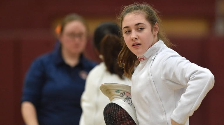 Olivia Becchina of Ward Melville finishes her epee bout against...