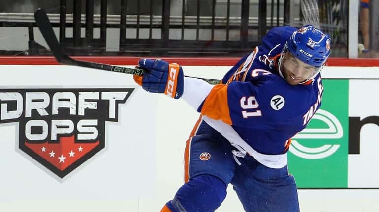 John Tavares #91 of the New York Islanders gets a...