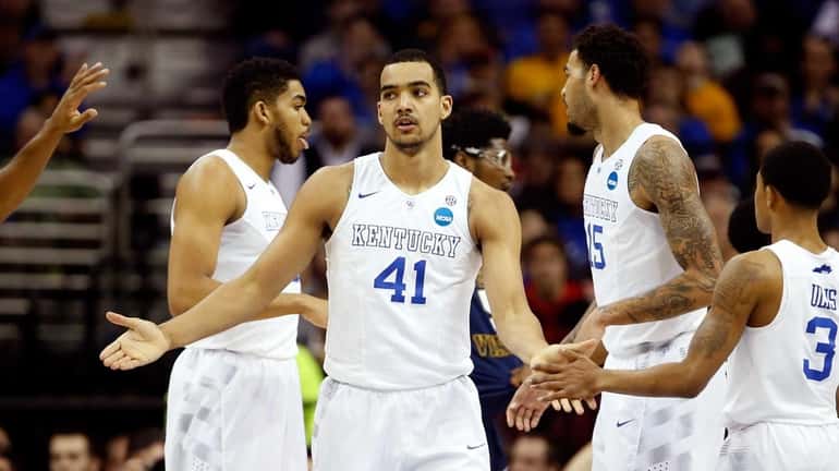 Trey Lyles of the Kentucky Wildcats reacts with teammates after...