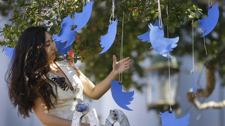 Twitter icons are hung in a tree in Sproul Plaza...