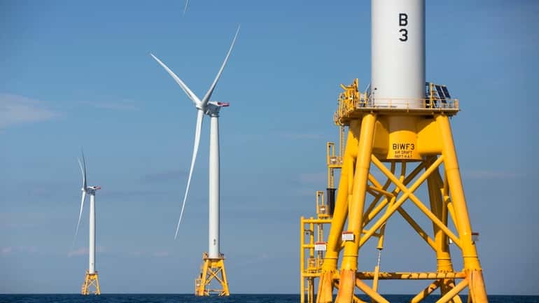 Wind turbines stand in the water off Block Island, Rhode...
