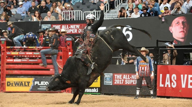 Cooper Davis rides a bull named Dead Calm at the...